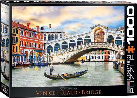 Eurographics jigsaw puzzle featuring the iconic Rialto Bridge in Venice. The scene depicts charming historic buildings, a gondola on the canal, and a vibrant sky, providing a colorful and engaging puzzle experience for enthusiasts.