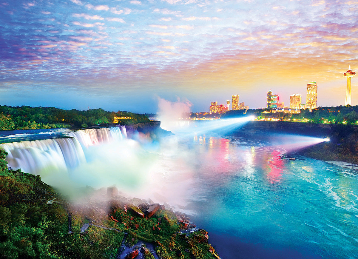 Eurographics Niagara Falls jigsaw puzzle showcasing a stunning view of the iconic falls illuminated at sunset, with vibrant colors and the skyline of nearby buildings in the background.