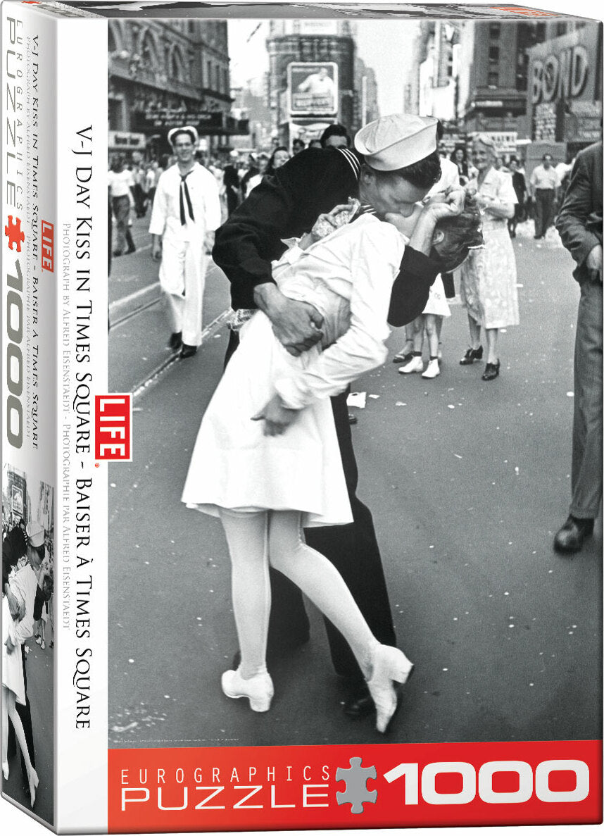 V-J Day Kiss in Times Square jigsaw puzzle box featuring a famous historical photograph capturing a sailor kissing a woman in a white dress amidst a bustling crowd celebrating the end of World War II. This 1000-piece puzzle by Eurographics showcases a nostalgic moment in American history, perfect for puzzle enthusiasts and history lovers alike.