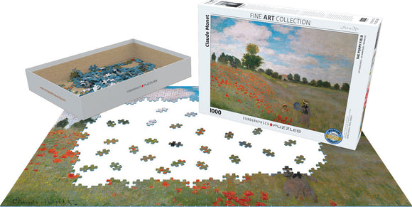 The Poppy Field jigsaw puzzle by Claude Monet, produced by Eurographics. The box features the iconic painting with a scenic field of red poppies and a blue sky. The surrounding area shows colorful puzzle pieces scattered on the table, ready to be assembled.