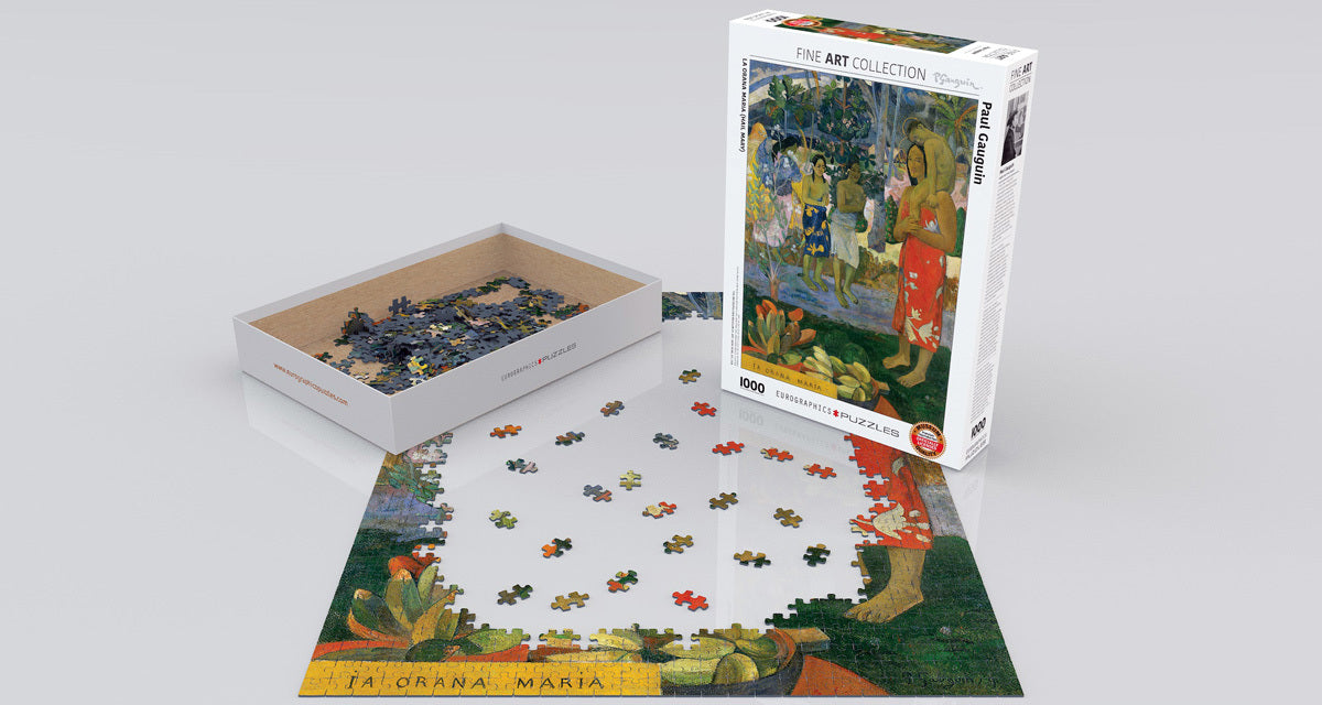 A 1000-piece jigsaw puzzle featuring Paul Gauguin's painting 'La Orana Maria' (Hail Mary). The box is partially open with some pieces scattered, showing vibrant colors and intricate details of tropical scenery and human figures. The puzzle is set on a flat surface, showcasing the beginning stages of assembly.