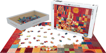 Castle and Sun by Paul Klee jigsaw puzzle from Eurographics. The puzzle features colorful abstract shapes, with a partially completed scene on a white surface. The box displays the artwork prominently, and loose pieces are arranged around it in a creative display.