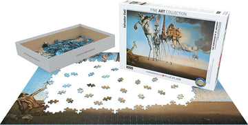 The Temptation of St. Anthony jigsaw puzzle by Eurographics, featuring a 1000-piece design. The box is shown with partially completed puzzle pieces arranged on a flat surface. The artwork depicts surreal imagery associated with Salvador Dali, showcasing vibrant blues and earth tones.