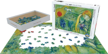 A jigsaw puzzle of 'The Lovers of Vence' by Marc Chagall displayed with scattered pieces. The box, labeled 'Fine Art Collection', sits beside a partially completed puzzle featuring vibrant greens and human figures. The scene reflects Chagall's artistic style with a blend of color and emotion.
