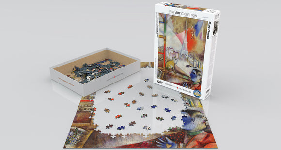 A jigsaw puzzle titled 'Paris through the Window' by Marc Chagall, featuring a colorful depiction of Paris with the Eiffel Tower. The puzzle box is partially opened, revealing scattered pieces on a flat surface, showcasing vibrant colors and artistic designs. This puzzle contains 1000 pieces, providing a challenging and enjoyable experience for art lovers and puzzle enthusiasts.
