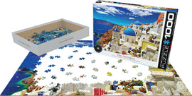 Eurographics jigsaw puzzle titled 'Oia, Santorini Greece' featuring 1000 pieces. The packaging shows a vibrant image of Santorini with blue domed roofs and stunning ocean views. A few scattered pieces are shown on a partially completed puzzle, demonstrating the delightful challenges of assembling this beautiful landscape.