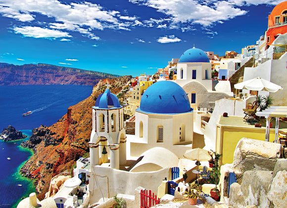 A vibrant Jigsaw puzzle featuring the stunning view of Oia, Santorini, Greece. The image showcases traditional white buildings with blue domes, the deep blue Aegean Sea, and dramatic cliffs under a bright blue sky with fluffy clouds. This captivating scene invites puzzle lovers to recreate the beauty of this iconic destination.