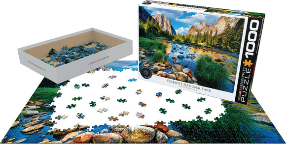 Yosemite National Park jigsaw puzzle by Eurographics featuring a 1000-piece scenic image of Yosemite's landscapes, with puzzle pieces scattered around the box and partially completed layout.