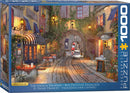 The French Walkway jigsaw puzzle by Dominic Davison showcases a charming street scene featuring cafes, blooming flowers, and a cyclist in a picturesque European town. The vibrant colors and intricate details invite puzzlers to immerse themselves in the scene, making it a delightful activity for art lovers.