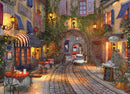 The French Walkway jigsaw puzzle featuring a picturesque French street scene with cafes, blooming flowers, and a cyclist riding through a quaint archway. Warm lighting illuminates the charming buildings adorned with colorful shutters and vines, inviting a sense of nostalgia and beauty.