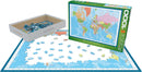 A 1000-piece jigsaw puzzle titled 'Map of the World' by Eurographics. The image shows the puzzle pieces scattered on a table with the box beside it, featuring a colorful world map. Some pieces are partially assembled, with blue oceans and vibrant landmasses visible.