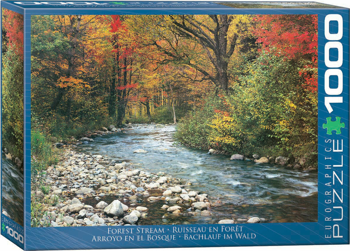 The 'Forest Stream' jigsaw puzzle by Eurographics features a serene landscape of a crystal-clear stream flowing through a forest adorned with fall foliage. The scene is rich with vibrant autumn colors and rocks lining the water, inviting nature enthusiasts and puzzle lovers alike.