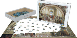 A vibrant jigsaw puzzle featuring Raphael's 'School of Athens'. The puzzle has 1000 pieces, displayed with some pieces scattered on a table. The puzzle box is white with the artwork cover and 'Eurographics' logo visible, highlighting its fine art collection.