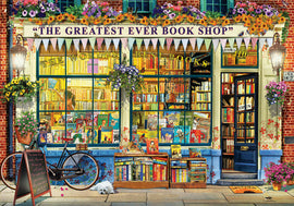A vibrant illustration of 'The Greatest Ever Book Shop', showcasing a charming storefront with books neatly displayed in large windows. A bicycle is parked outside, and a small white dog lies on the steps. Colorful flowers adorn the shop entry, adding a whimsical touch to the scene. The shop's name is prominently displayed with banners, creating a warm and inviting atmosphere for book lovers.