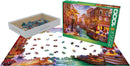 A jigsaw puzzle titled 'Sunset Over Venice' by Dominic, produced by Eurographics. The image shows a 1000-piece puzzle partially assembled with colorful pieces depicting a vibrant sunset scene over a Venetian canal, with a box and pieces scattered around.