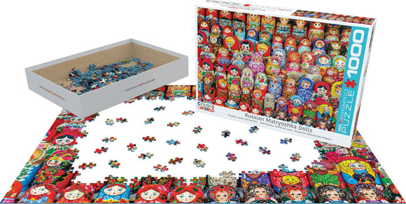 A 1000-piece jigsaw puzzle featuring vibrant designs of Russian Matryoshka dolls. The puzzle pieces are scattered on a surface, showcasing various colorful patterns of the dolls, with the box visible showing the full image of the completed puzzle.