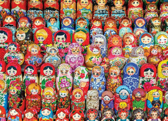 A colorful display of Russian Matryoshka dolls, known as nesting dolls, featuring intricate hand-painted designs and various facial expressions. The dolls are arranged in a vibrant pattern showcasing multiple layers and styles, each decorated with flowers, traditional clothing, and cultural motifs.
