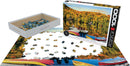 Lakeside Cottage jigsaw puzzle from Eurographics depicting a serene lakeside scene in Quebec. The puzzle has 1000 pieces, featuring colorful boats and vibrant autumn foliage. The image shows the box, pieces scattered on a table, and part of the completed puzzle, capturing the tranquility of a cottage by the lake.