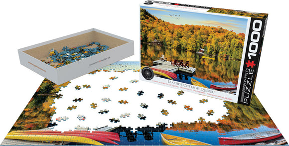 Lakeside Cottage jigsaw puzzle from Eurographics depicting a serene lakeside scene in Quebec. The puzzle has 1000 pieces, featuring colorful boats and vibrant autumn foliage. The image shows the box, pieces scattered on a table, and part of the completed puzzle, capturing the tranquility of a cottage by the lake.