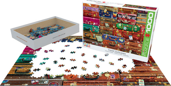 Eurographics Travel Suitcases jigsaw puzzle featuring an artistic arrangement of colorful, vintage suitcases. The image shows the puzzle pieces scattered on a flat surface, with the puzzle box displayed nearby. Ideal for puzzle enthusiasts and travel lovers, this 1000-piece puzzle provides a fun and engaging challenge.