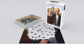 A jigsaw puzzle of the famous painting 'American Gothic' by Grant Wood, made by Eurographics. The puzzle features a partially completed image with pieces scattered around a neatly designed box. The box showcases the iconic artwork depicting a farmer and his daughter in front of a farmhouse, emphasizing fine art and challenging puzzle-solving.