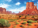 Monument Valley jigsaw puzzle by Eurographics featuring a stunning landscape of sandstone formations and vibrant blue sky. Ideal for puzzle lovers who appreciate natural beauty.