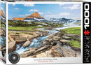 A beautifully illustrated jigsaw puzzle featuring the stunning landscape of Glacier National Park in Montana, USA. The image shows rocky formations, lush green meadows, and snow-capped mountains under a blue sky, capturing the essence of this natural wonder.