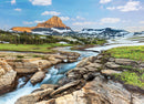 Glacier National Park jigsaw puzzle by Eurographics, featuring a stunning landscape with a majestic mountain in the background, lush greenery, flowing water, and snow-capped peaks under a bright blue sky. Perfect for nature enthusiasts and puzzle lovers alike.
