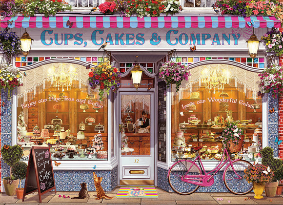 A beautifully illustrated jigsaw puzzle titled 'Cups, Cakes & Company' by Eurographics. The image depicts a charming bakery storefront adorned with colorful flowers, a bicycle, and a chalkboard sign inviting customers. Through the glass window, an array of delectable cakes and pastries can be seen, alongside a friendly waiter. The detailed artwork evokes a warm and inviting atmosphere, making it perfect for puzzle enthusiasts and bakery lovers alike.
