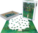A 1000-piece jigsaw puzzle titled 'Woman Walking in an Exotic Forest' by Eurographics. The puzzle features a vibrant artwork by Henri Rousseau, depicting a woman in a lush green forest filled with colorful flowers and foliage. The pieces are spread out around the partially completed puzzle with a white box nearby.