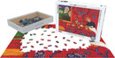 A jigsaw puzzle titled 'The Dessert: Harmony in Red' by Eurographics. The puzzle features a vibrant red background with colorful details, showing a table set with fruits and decorative elements. The box displays the artwork, alongside scattered puzzle pieces on a white surface, ready for assembly. It is designed for puzzle enthusiasts, offering a challenging and artistic experience.