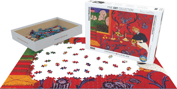 A jigsaw puzzle titled 'The Dessert: Harmony in Red' by Eurographics. The puzzle features a vibrant red background with colorful details, showing a table set with fruits and decorative elements. The box displays the artwork, alongside scattered puzzle pieces on a white surface, ready for assembly. It is designed for puzzle enthusiasts, offering a challenging and artistic experience.