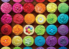 Colorful jigsaw puzzle featuring a vibrant arrangement of beautifully decorated cupcakes in various colors and frosting styles, set against a rustic wooden background.
