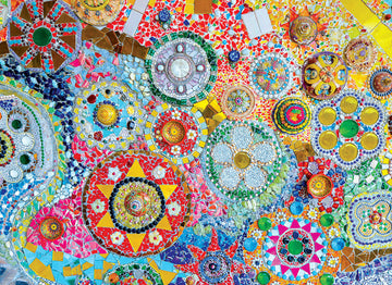 A vibrant jigsaw puzzle titled 'Thai Mosaic' by Eurographics, featuring an intricate design of colorful mosaic patterns. The puzzle showcases a blend of various shapes and colors, including stars, circles, and floral motifs, creating a visually stunning artwork that invites creativity and relaxation.