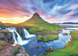 A scenic jigsaw puzzle featuring Kirkjufell Mountain in Iceland. The image showcases the iconic mountain with a stunning waterfall in the foreground surrounded by lush greenery and a colorful sunset sky, perfect for puzzle enthusiasts.