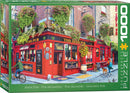 A vibrant jigsaw puzzle box titled 'The Irish Pub' by Eurographics. The artwork showcases a lively red pub adorned with colorful flowers, street signs, and people enjoying the day outside. The box displays the puzzle details and a scenic background, making it an inviting choice for puzzle enthusiasts.
