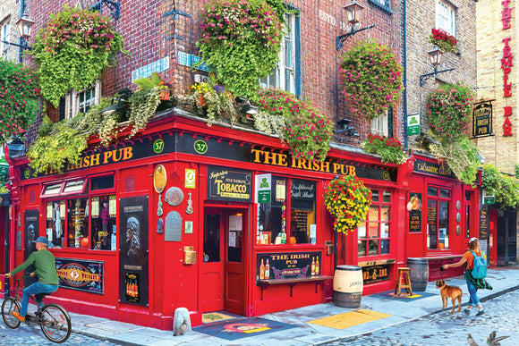 A vibrant street scene featuring 'The Irish Pub,' a colorful red-brick pub adorned with lush flower baskets and vintage signage. The pub showcases outdoor seating, a bicycle rider passing by, a woman walking her dog, and signs highlighting live music and traditional Irish culture.