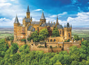 A beautifully detailed jigsaw puzzle featuring Hohenzollern Castle in Germany, showcasing its magnificent architecture with towers and turrets set against a vibrant blue sky and lush greenery surrounding the castle.