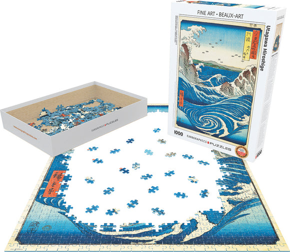 Eurographics Naruto Whirlpool jigsaw puzzle featuring intricate blue waves and a scenic landscape by Utagawa Hiroshige. The image showcases the 1000 pieces arranged partially completed, along with the box containing the remaining pieces, emphasizing its artistic detail and vibrant colors.