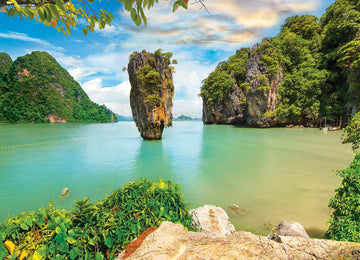 A vibrant jigsaw puzzle titled 'Pacific Islands' featuring a stunning scenic depiction of tropical landscapes. The image showcases rocky formations, lush greenery, and crystal-clear turquoise waters under a bright blue sky with fluffy clouds, perfect for puzzle enthusiasts appreciating nature's beauty.