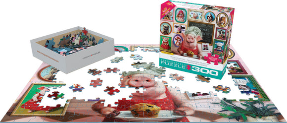 A vibrant jigsaw puzzle titled 'Delicious Goodies' by Eurographics, featuring a whimsical scene with a pig in a chef's hat holding a cookie. The completed puzzle showcases colorful images of various baked goods and decorative frames. A box containing puzzle pieces sits beside it, with some pieces scattered on the table, indicating the joy of piecing together this engaging puzzle.