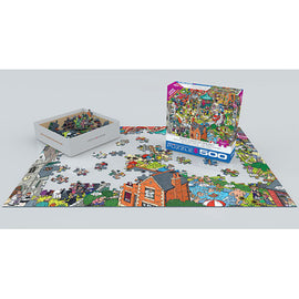 A vibrant jigsaw puzzle titled 'What Could Go Wrong?' by Eurographics is showcased with its box displayed. The puzzle features colorful, whimsical artwork spread out on a white surface, with several pieces already placed and a box of loose pieces nearby. The scene includes various buildings, characters, and playful elements, inviting puzzlers of all ages to engage in this fun challenge.