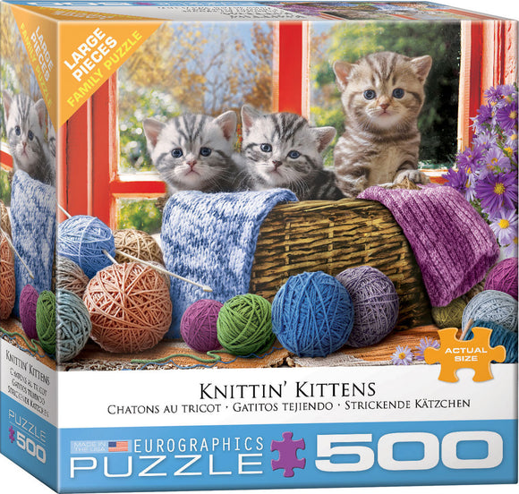 The Knittin' Kittens jigsaw puzzle box by EuroGraphics features three adorable kittens nestled in a basket surrounded by colorful yarn balls and knitting supplies. A sunny window view adds warmth to the scene, highlighting the cozy atmosphere perfect for family fun.