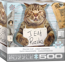 The Feline Felon jigsaw puzzle by Eurographics features a comical illustration of a large, grinning cat holding a sign that says 'I EAT Puzzles.' The background shows a height chart and wanted posters, adding to the playful theme of the puzzle. It is designed for puzzle enthusiasts with 500 large pieces, ideal for a fun and engaging activity.