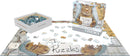 The Feline Felon jigsaw puzzle box by Eurographics rests next to a partially completed puzzle on a flat surface. The puzzle features a humorous image of a cat holding a sign that says 'I EAT Puzzles' against a playful background. The open box displays colorful puzzle pieces, while several pieces are scattered around the puzzle.
