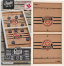 The Rustik Fast Sling Puck game by Family Games Inc features a wooden design with two compartments. The top section shows the game setup with black pucks on a brown background, labeled 'Fast SlingPuck'. The game is suitable for 2 players aged 4 and up and encourages action and dexterity. Handmade in Canada, it emphasizes family gameplay.