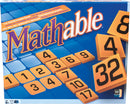 Mathable Classic game box featuring a vibrant blue background with large orange and black numbered tiles visible. The title 'Mathable' is prominently displayed in purple and white lettering, indicating a fun cross-number math challenge for players aged 9 and up. The game is suitable for 2 or more players and emphasizes strategic thinking and numerical skills.