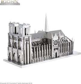 A detailed 3D model of Notre Dame Cathedral made from metal, featuring intricate gothic architecture with spires, flying buttresses, and a large rose window. The model is displayed on a flat base, showcasing the precision of the design and craftsmanship.