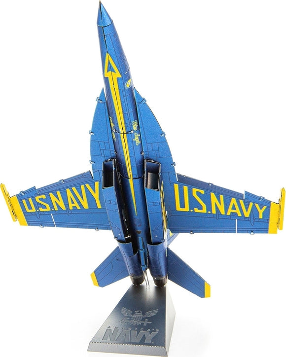 A detailed model of the Blue Angels F/A Super Hornet by Fascinations. The model features a striking blue and yellow color scheme with 'U.S. NAVY' emblazoned on its wings and body. It is mounted on a sleek gray stand displaying the Navy insignia. The aircraft's sleek design showcases its aerodynamic features, perfect for aviation enthusiasts and collectors.