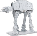 The ICONX Imperial AT-AT by Fascinations is a detailed DIY kit featuring a metallic structure with intricate details. The iconic All Terrain Armored Transport is depicted in a standing position, showcasing its iconic legs, cockpit, and weapons. The model features a sleek gray finish and is displayed on a flat base, perfect for collectors and Star Wars fans.